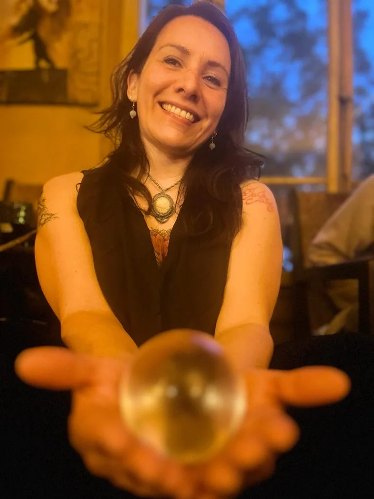 Irene holding a glowing sphere of light during a channeling session