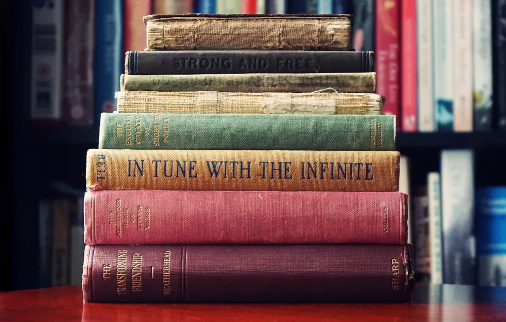 A stack of old books on spiritual practice, including In Tune With The Infinite