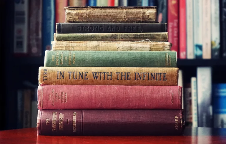 A stack of old books on spiritual practice, including In Tune With The Infinite